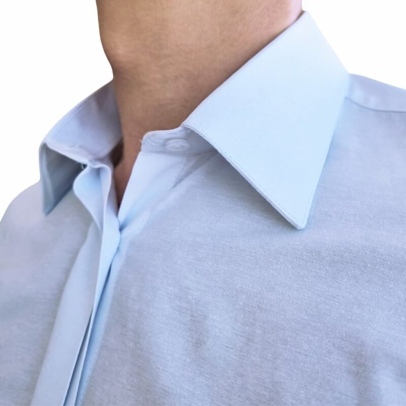 Close da gola francesa e do tecido da camisa branca lisa, evidenciando textura suave, estrutura e acabamento premium.
