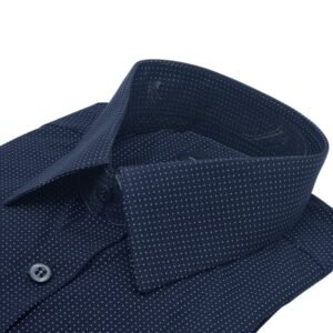 Close lateral da gola francesa da camisa azul marinho com estampa de poá azul claro em destaque.