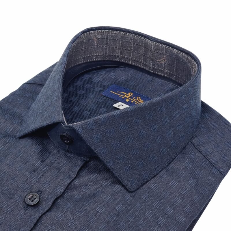 Close em ângulo da gola italiana rígida da camisa preta xadrez, mostrando colarinho, parte da vista com botões e a textura do tecido.