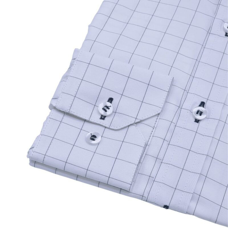 Detalhe do punho com botões e parte da manga da camisa social branca quadriculado azul escuro em tecido passa fácil.