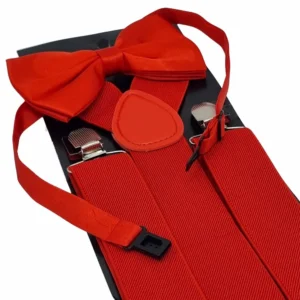 Gravata borboleta vermelha em primeiro plano sobre o suspensório do kit, com as presilhas