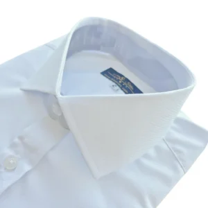Colarinho italiano estendido visto de cima, com a textura maquinetada da camisa branca